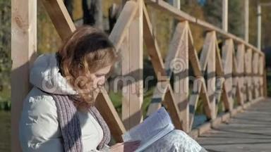 秋河附近的桥上，一个女人看书喝<strong>茶</strong>